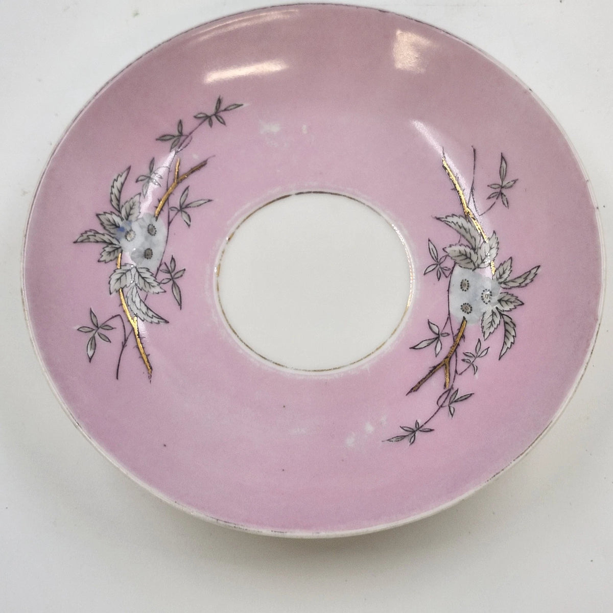Vintage pink and white porcelain saucer with floral design and gold accents