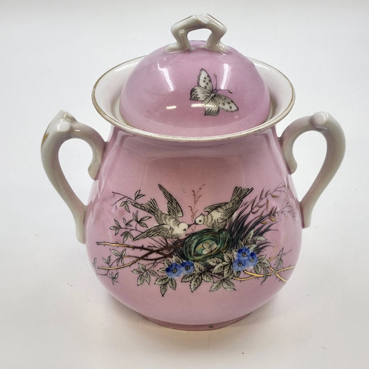 Vintage pink porcelain biscuit jar with birds, flowers, butterfly, and gold trim