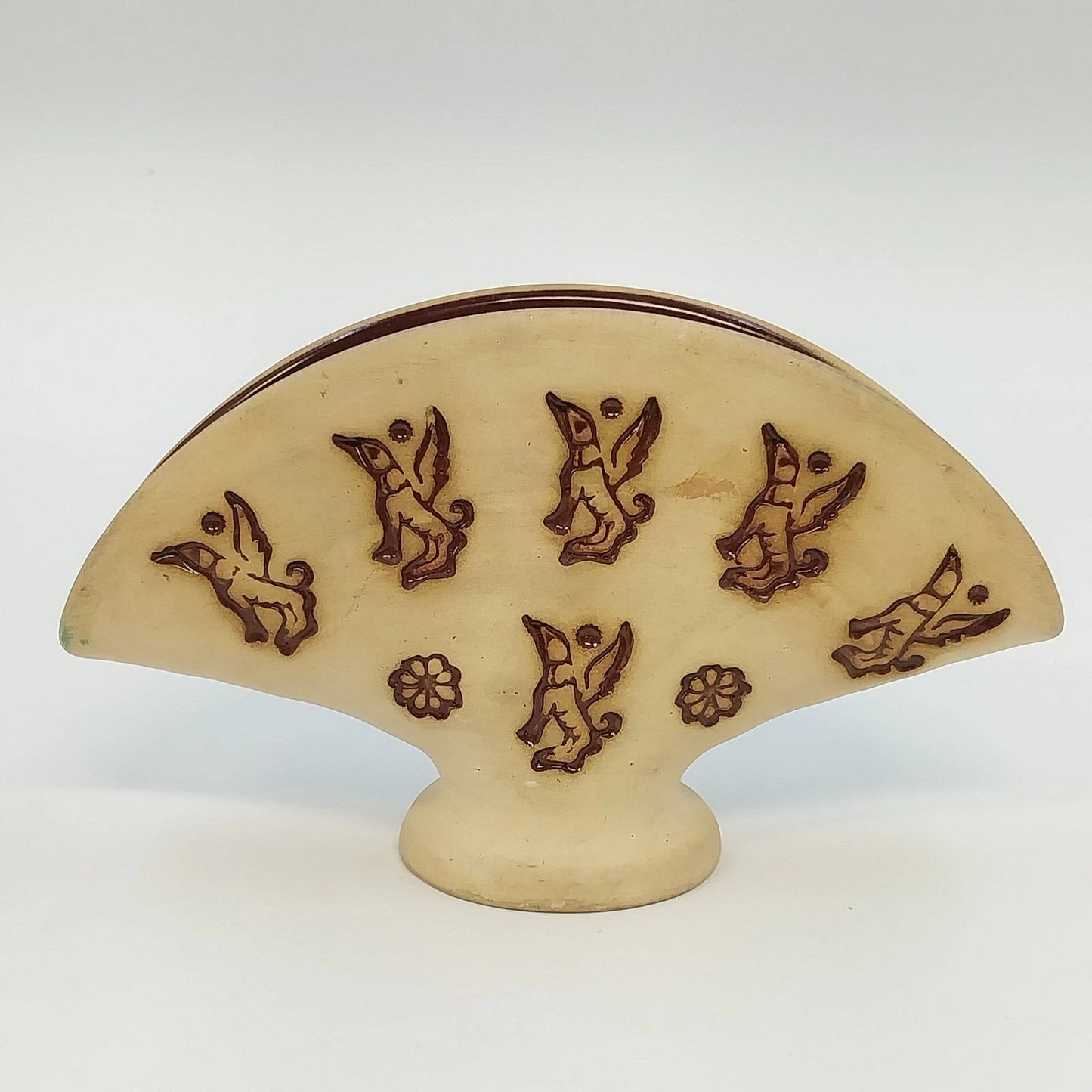 Vintage beige pottery napkin holder with brown flying dog motif