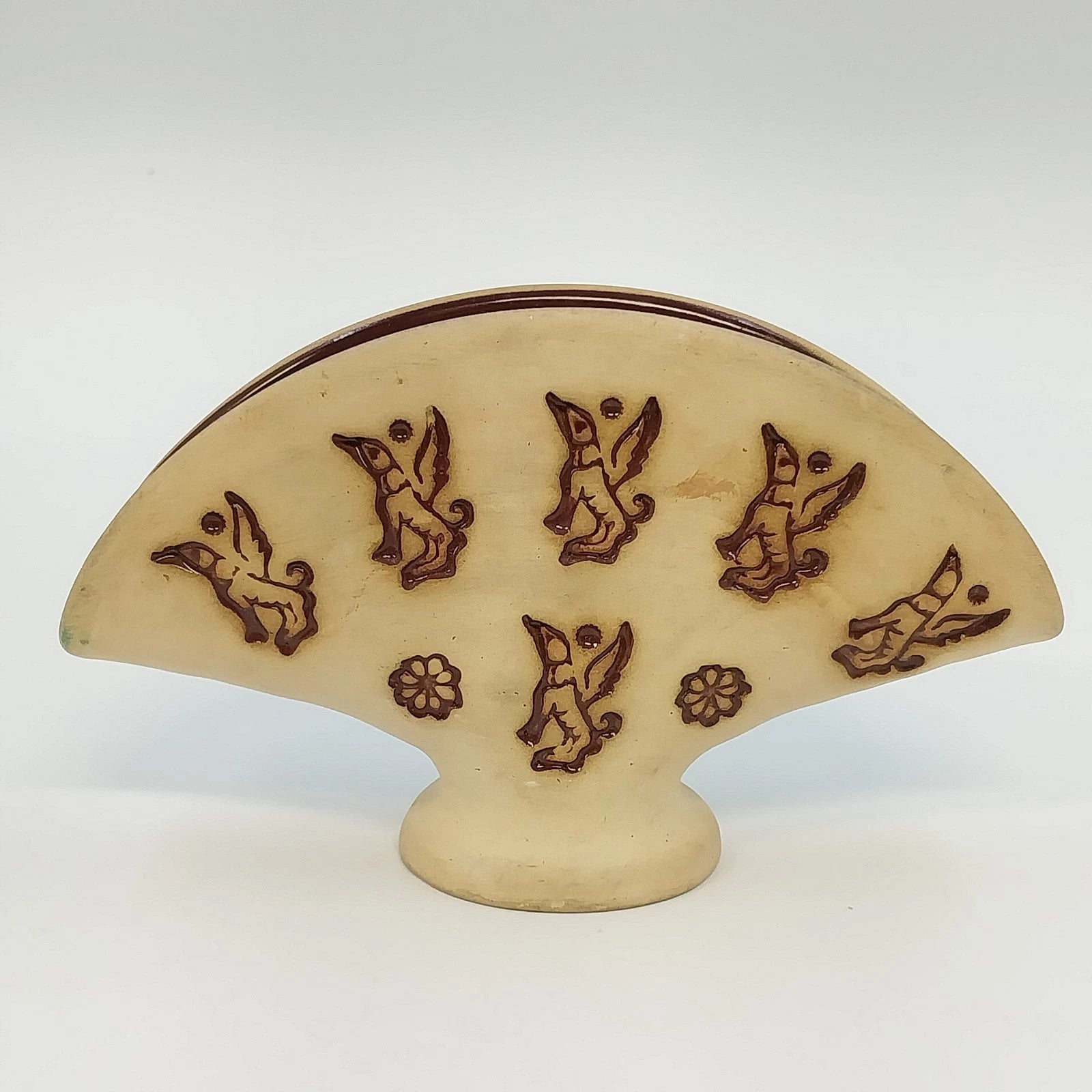 Vintage beige pottery napkin holder with brown flying dog motif