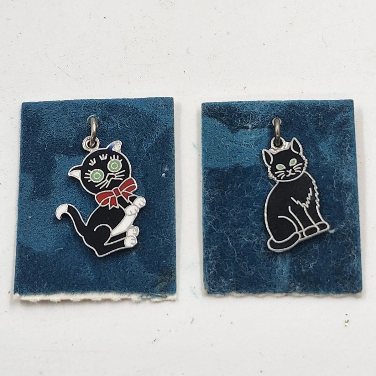 Pair of vintage black cat charms with green eyes and silver-tone details