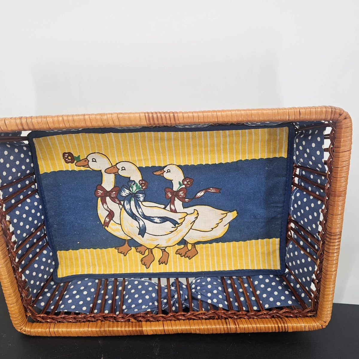 Vintage wicker storage basket with blue polka dot goose fabric liner