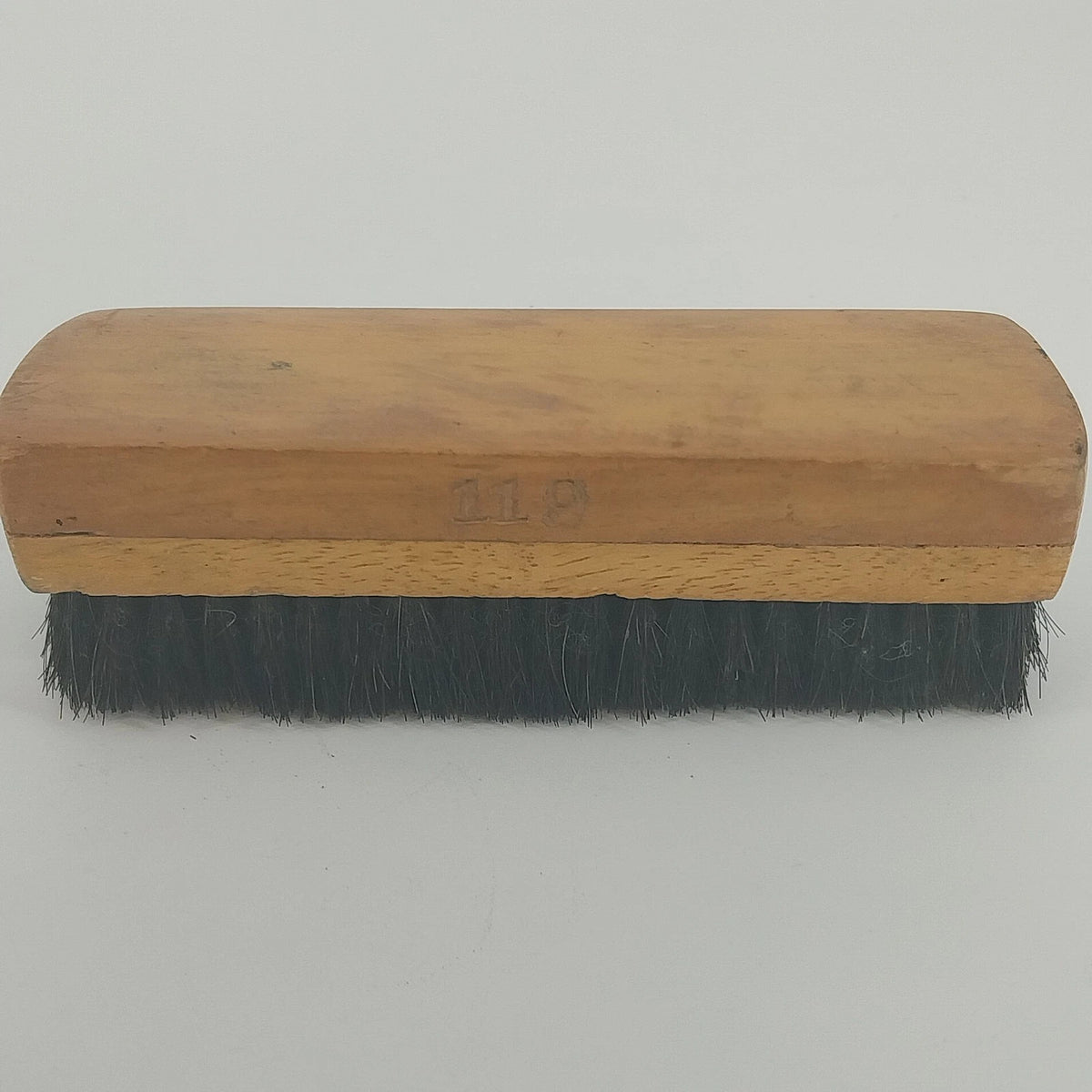 Vintage wooden shoe polish brush with black bristles and 119 stamp