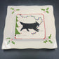 Vintage ceramic platter with black dog pulling a red and green Christmas sled