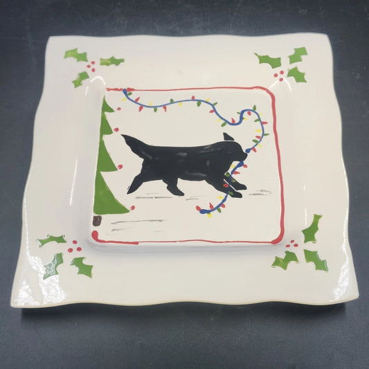 Vintage ceramic platter with black dog pulling a red and green Christmas sled