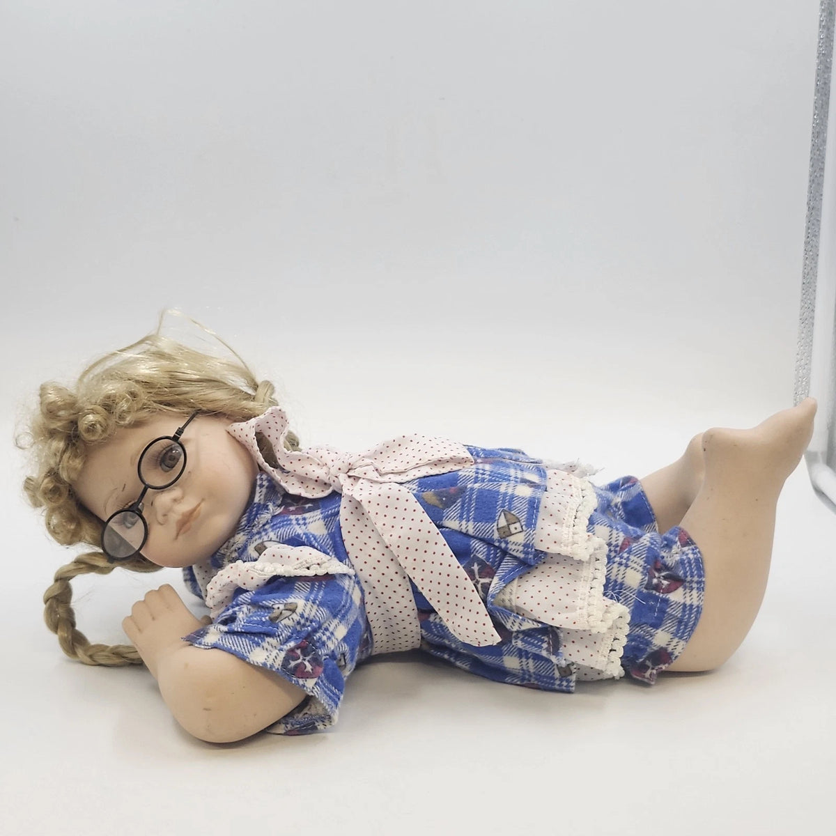 14-inch vintage porcelain girl doll with blonde braids and blue plaid dress